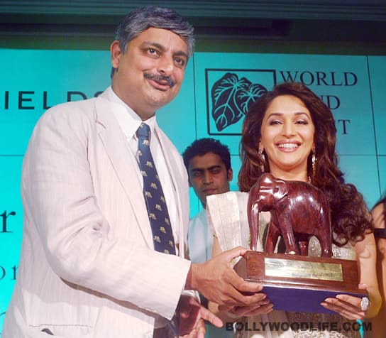She accepts a token of appreciation from a brand official