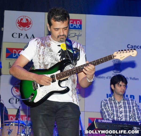 Ehsaan strums the guitar 