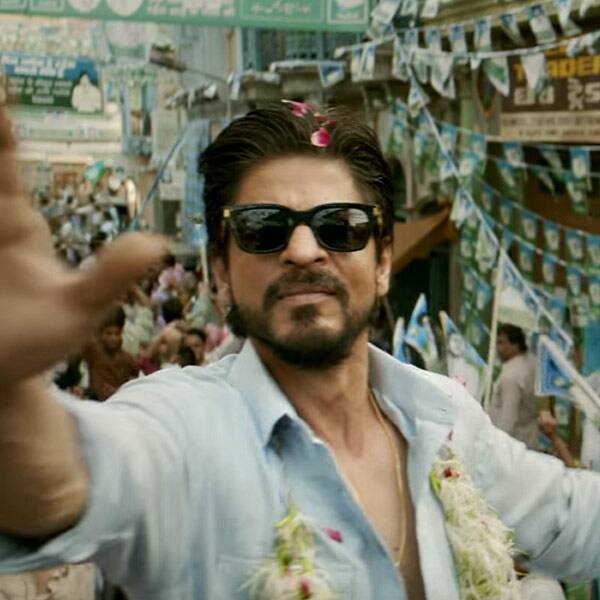 Shah Rukh looks adorable as he is being showered with flower petals