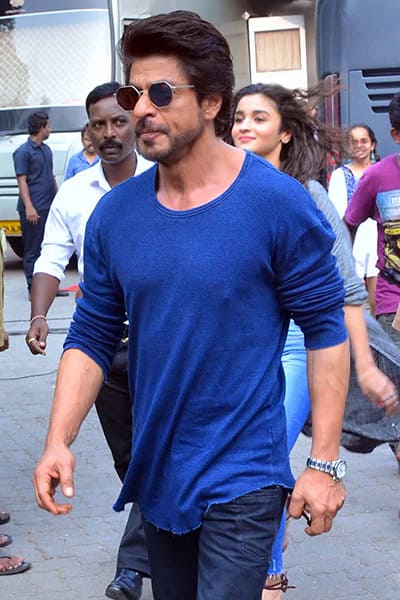 Alia Bhatt walking behind Shah Rukh with a smile is hard to ignore