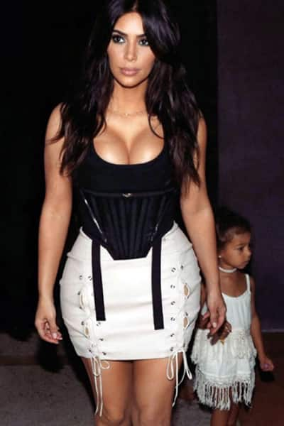 Kim was snapped in Cuba wearing a fitted black top tucked in the body hugging mini skirt along with her daughter North West and looked like a hot Mama indeed.