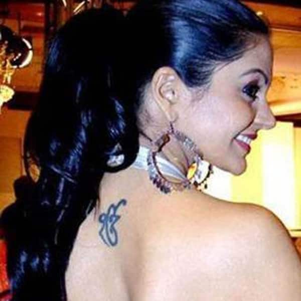 Mandira Bedi flaunting the tattoo on her back
