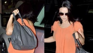 Preity Zinta hides her bubbly self behind dark glasses and a bright orange dress!
