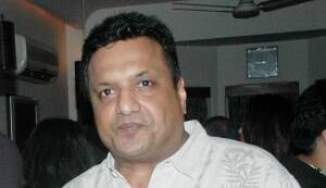 Why is Sanjay Gupta comparing himself to Karan Johar?