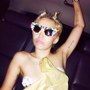 Miley Cyrus goes topless at party