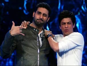 After Happy New Year, what is Shah Rukh Khan helping Abhishek Bachchan with?