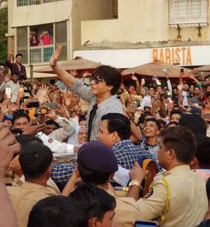 Shah Rukh Khan gets on top of his car's roof to greet fans outside his residence and the reaction is magical - watch videos