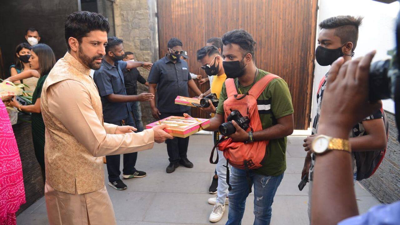 Farhan Akhtar hands out sweets to paparazzi