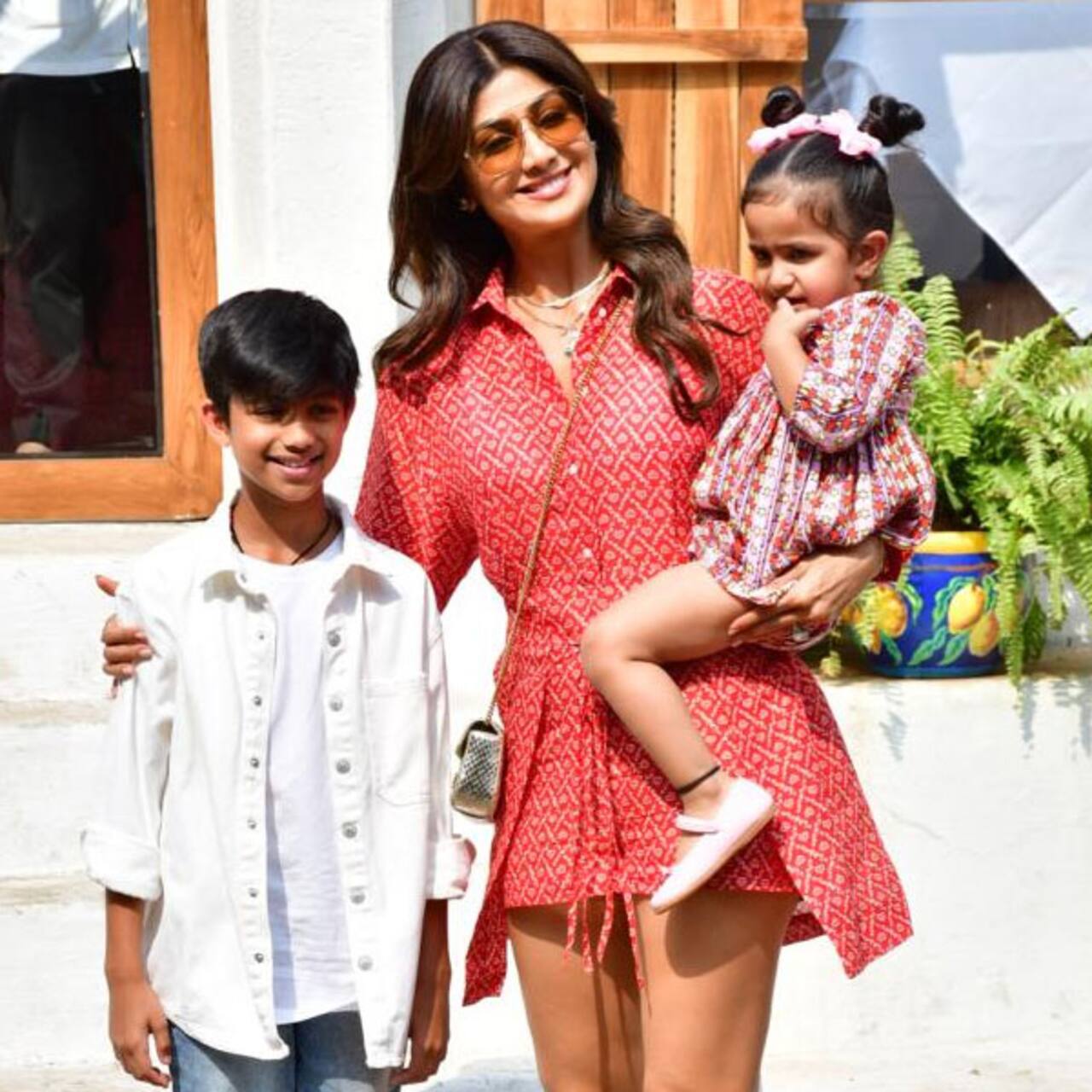 Shilpa Shetty looks a one hot mommy in this little orange dress