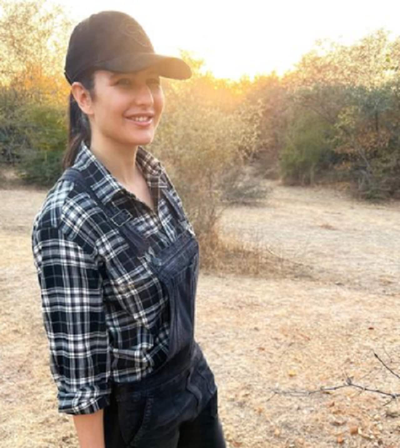 Katrina Kaif looks chic in this black dungaree paired with a checkered shirt