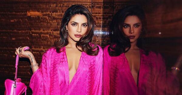 Priyanka Chopra makes a style statement in a top-to-toe bubblegum pink plunging neckline dress; hubby Nick Jonas cannot get enough of her