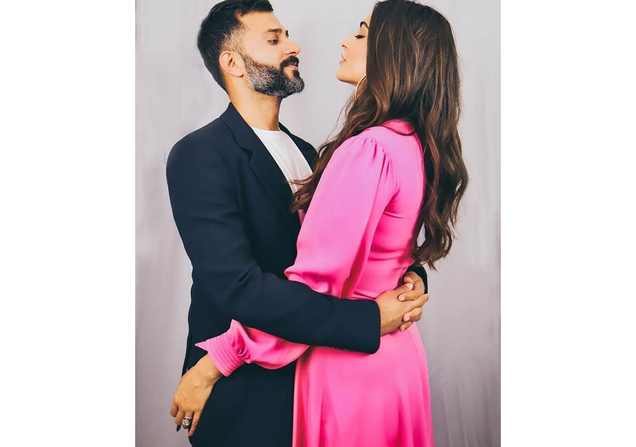 Anand Ahuja and Sonam Kapoor are wrapped in each other's arms.