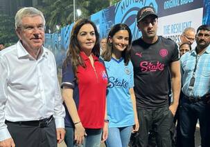 Ranbir Kapoor and Alia Bhatt walk hand-in-hand at an event; twin in number '8' jerseys
