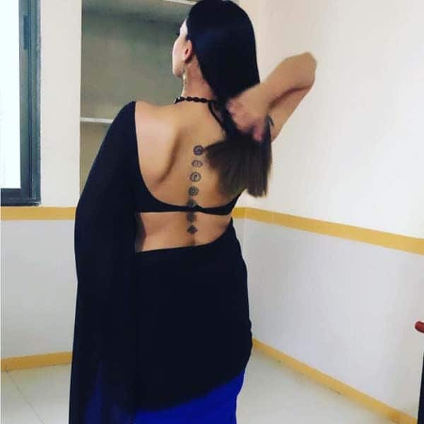 Vivek Oberoi's wife Priyanka showed off her tattoo in a backless saree  blouse during the International Indian Film Academy (IIFA) awards in  Singapore on June 9, 2012