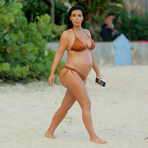 Pregnant Kim Kardashian taking a stroll by the beach in a bikini Pregnant Kim Kardashian taking a stroll by the beach in a bikini